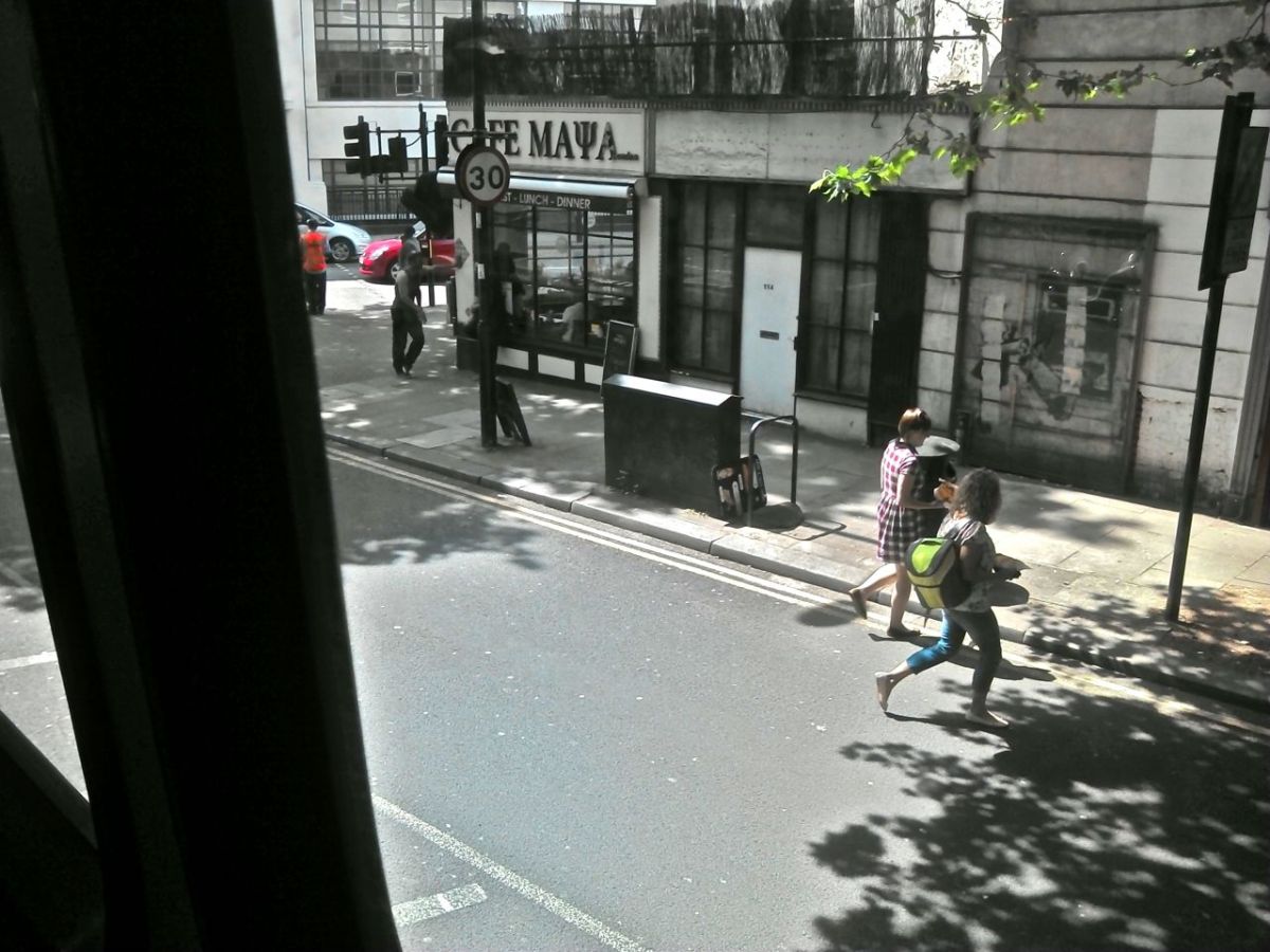 street view from bus with Banksy on wall